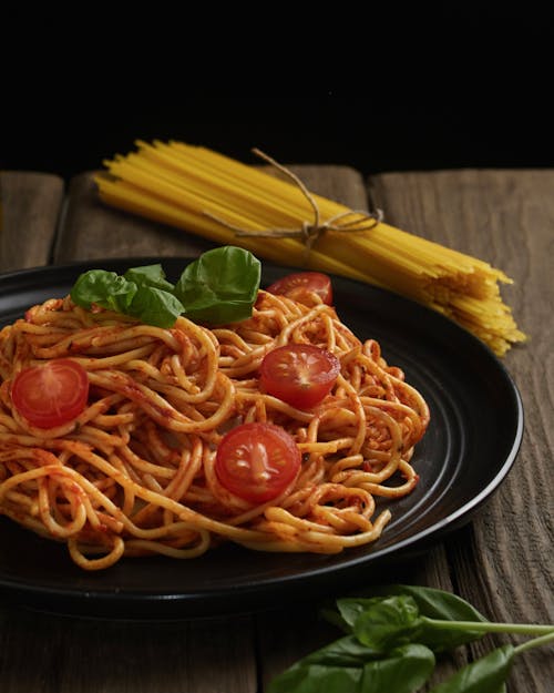 Pasta With Red Sauce on Black Ceramic Plate