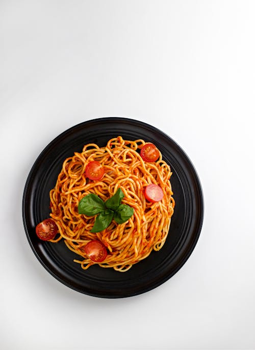Pasta with Cherry Tomatoes on Black Plate