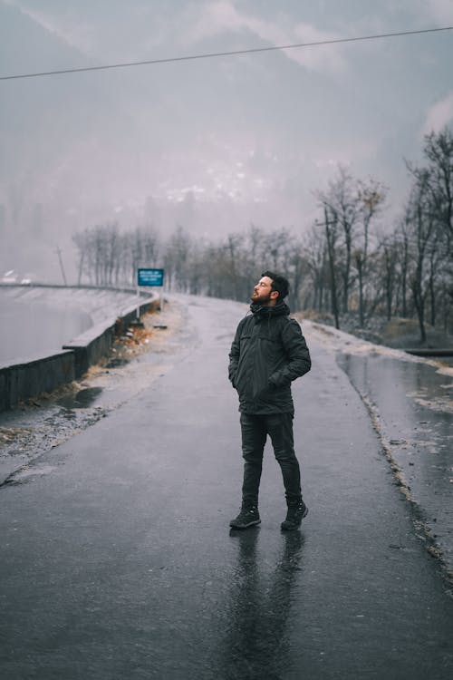 Man Standing on Street While Looking Up