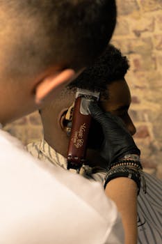 Expert barber giving a precise haircut to a client at a barbershop in Brussels.