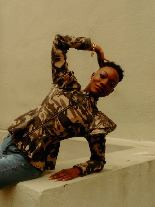 A Woman in Camouflage Long Sleeves Posing at the Camera