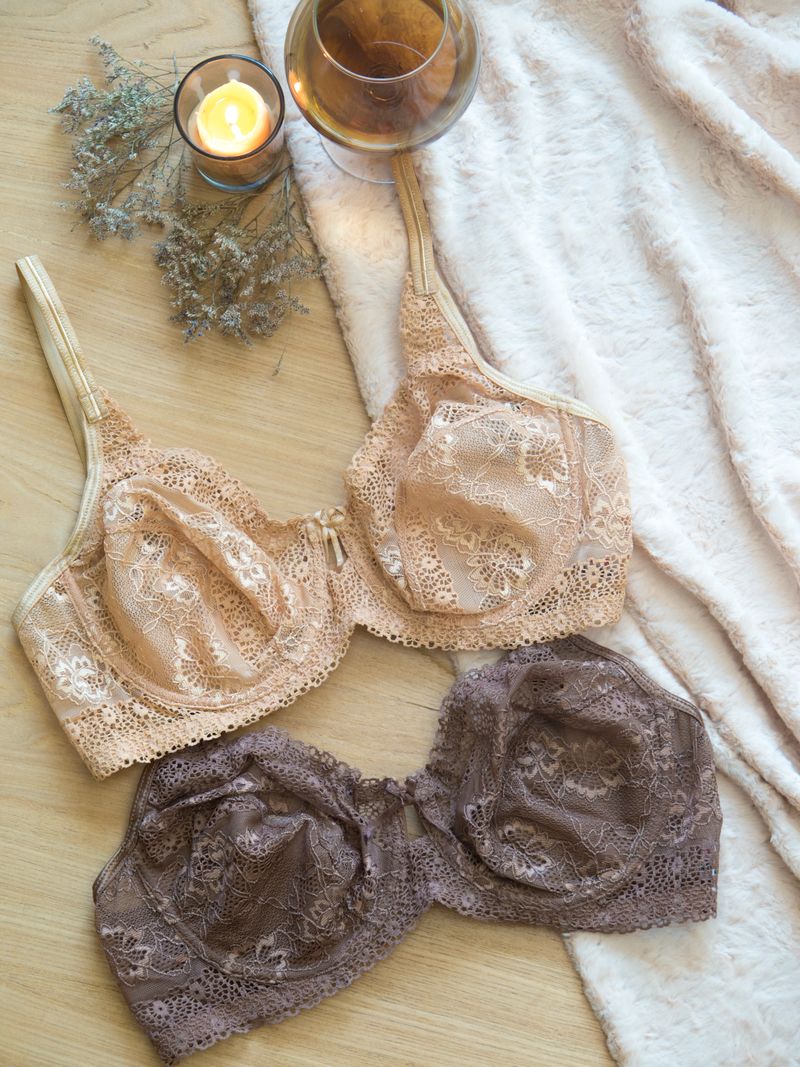 Sophisticated flatlay of lace lingerie with champagne and warm candlelight — Velvet Thread Ivory Curve collection