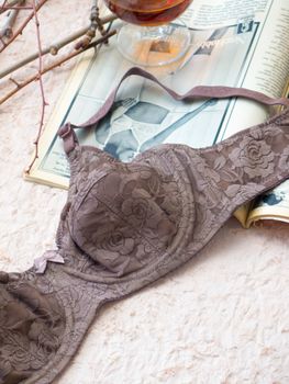 Stylish lace brassiere on vintage magazine background showcasing lingerie fashion.
