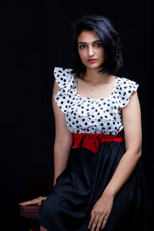 A Woman in White and Black Polka Dot Top