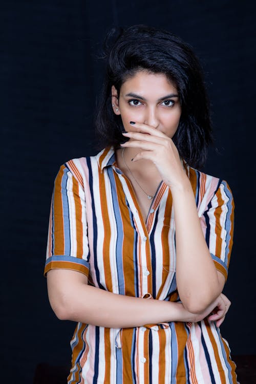 A Woman in Striped Button-Up Shirt 