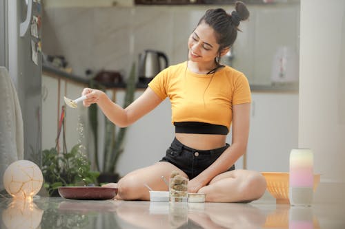 Woman Sitting on a Kitchen Counter 