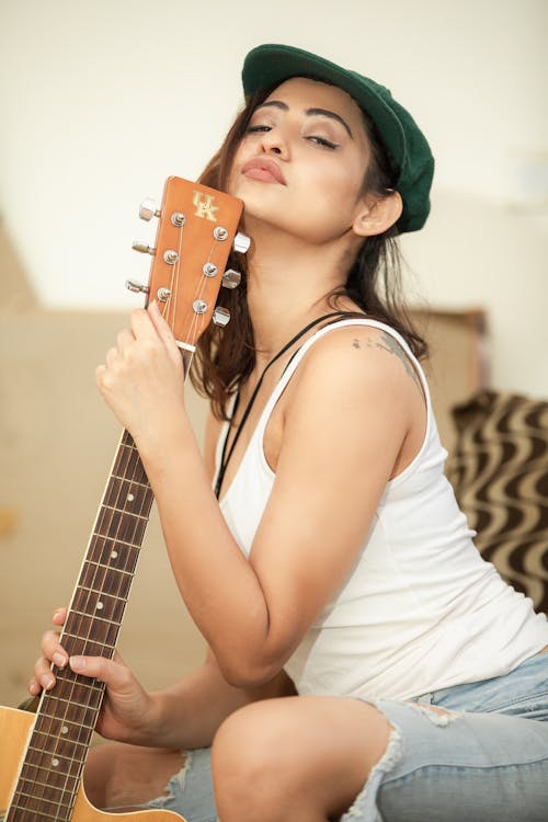 Woman in White Tank Top Holding Brown Guitar