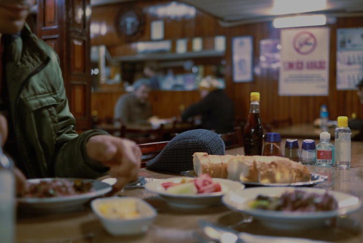 A Person Eating The Foods On The Table