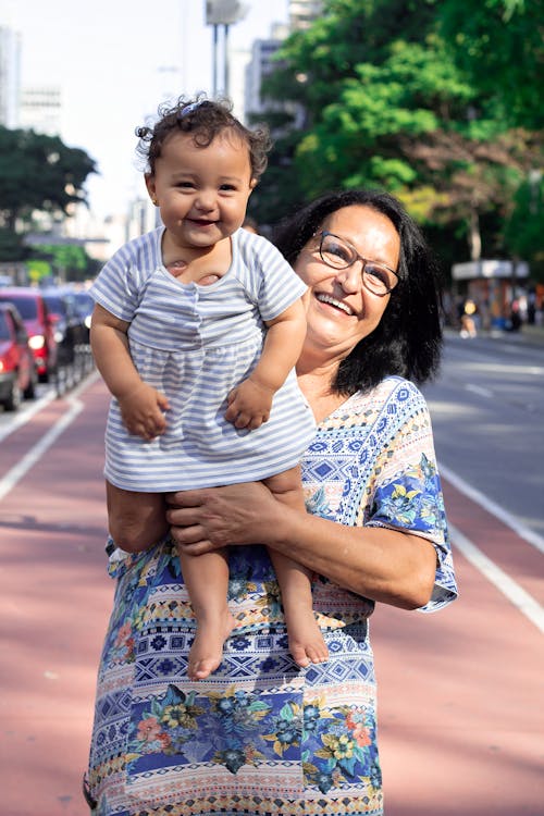 Laughing Grandmother Holding her Grandchild