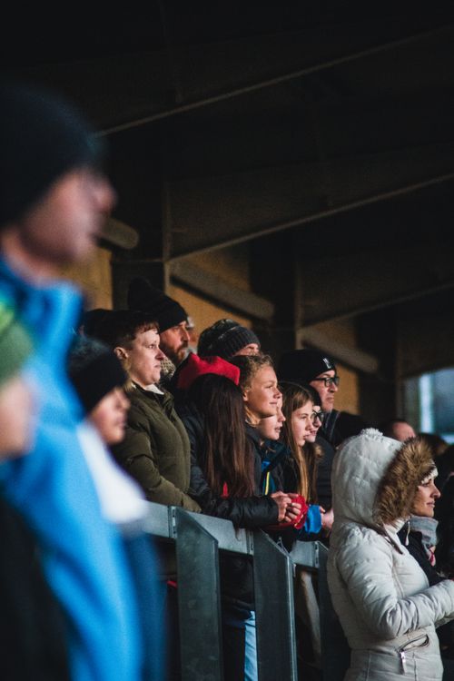 Free A diverse group of people warmly dressed, watching an event in a stadium. Stock Photo