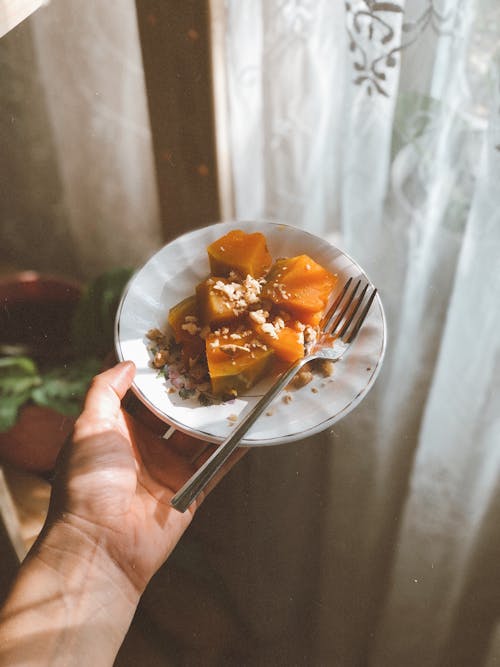 Man Holding a Plate with Food 