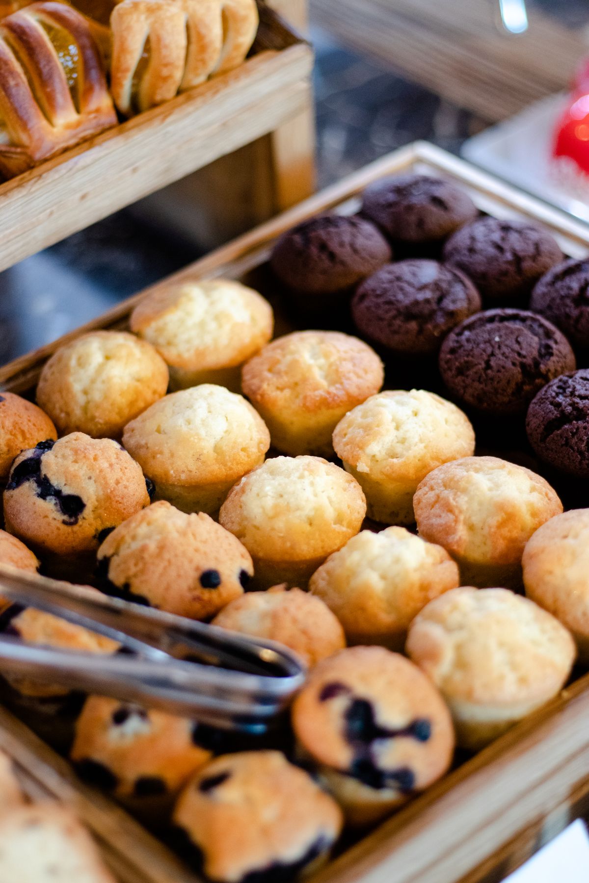 Cupcakes and muffins on a wooden tray