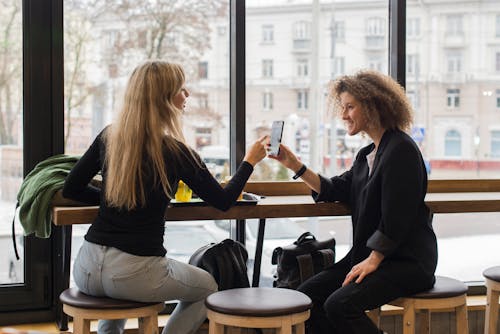 Woman Showing Cellphone to a Woman