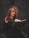 Woman in Black Long Sleeve Shirt Holding Black Book