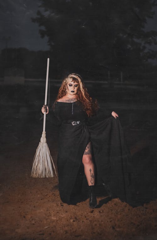Portrait of Woman in Witch Costume Holding Broom