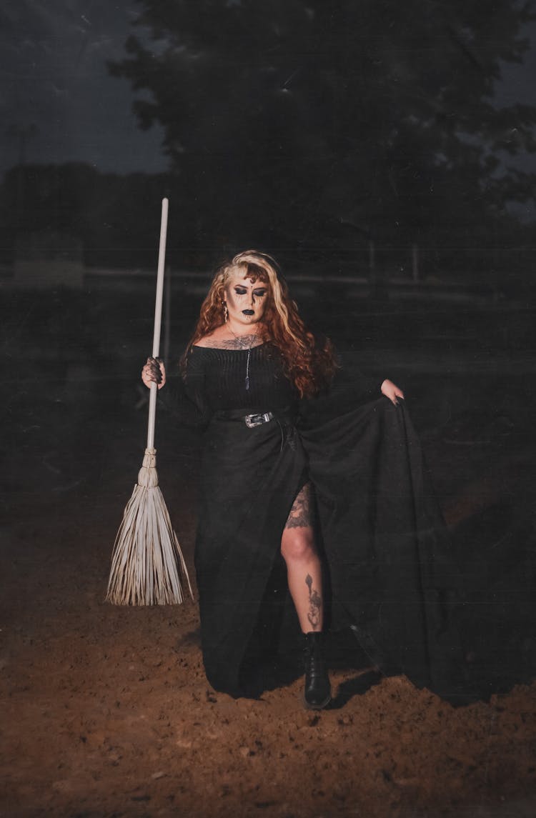 Portrait Of Woman In Witch Costume Holding Broom