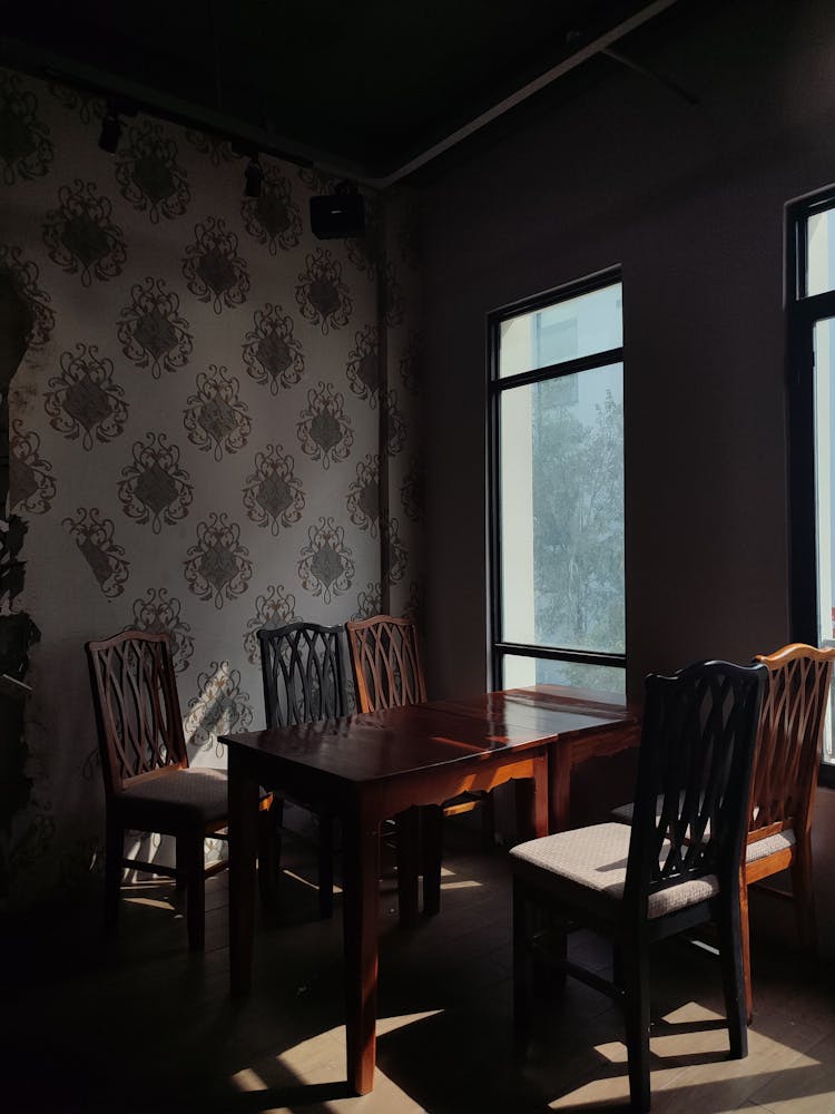 Dark Wooden Table And Chairs In Corner Of Room