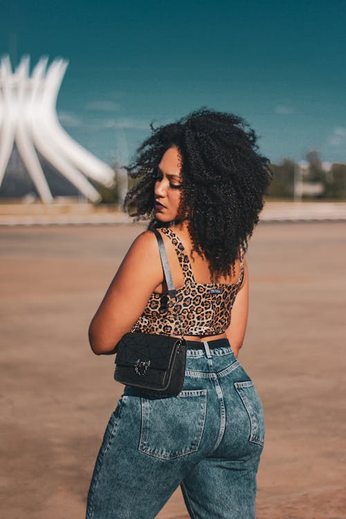 Woman with Curly Hair Wearing Leopard Print Top