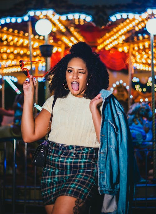 Woman in White Top Sticking Her Tongue Out