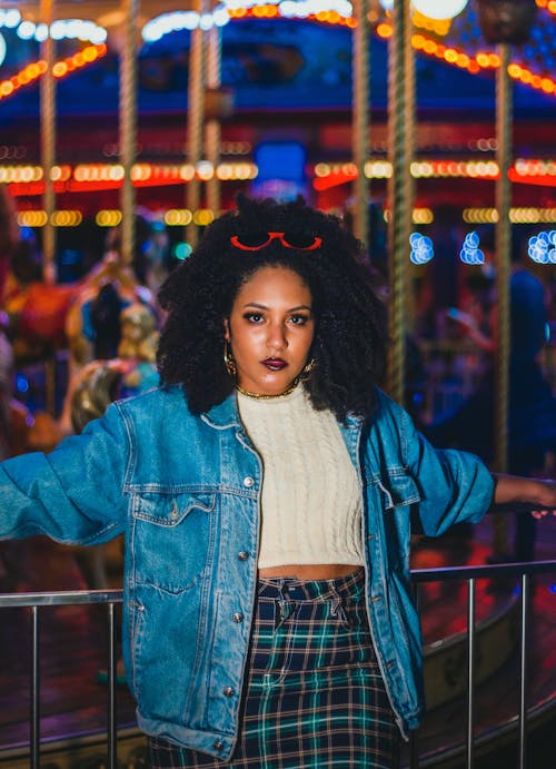 Woman in Denim Jacket Leaning on a Railing