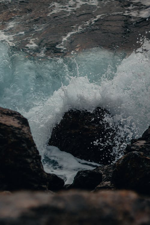 Ocean Waves Hitting Brown Rock