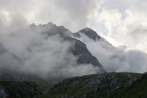 Green Moss on Gray Rocky Mountains Under White Clouds