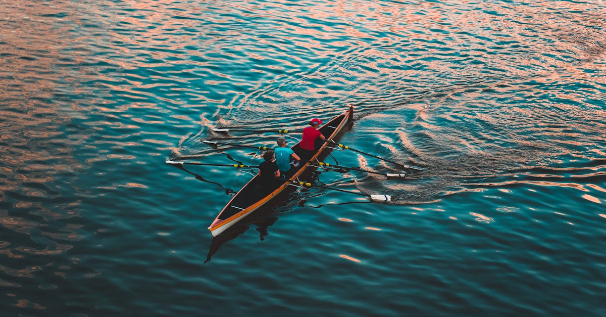 Three People on Brown Canoe Sailing on Calm Water · Free Stock Photo