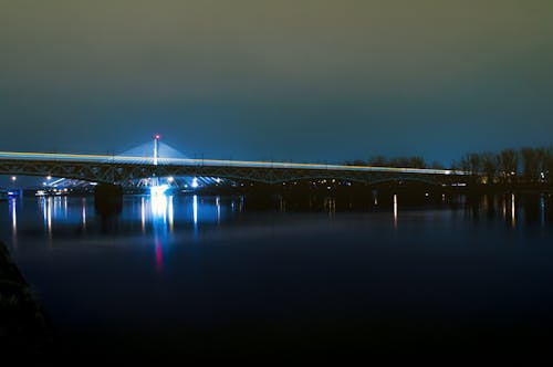 Body of Water With Bridge at Night