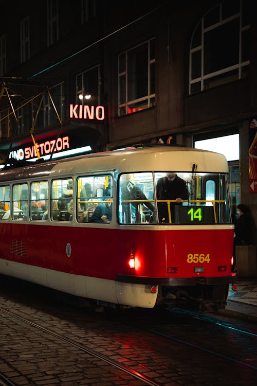 Free Red and White Tram on Road at Night Stock Photo