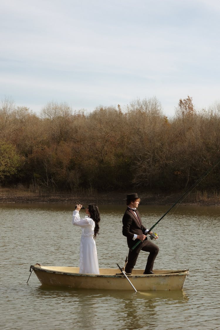 Man And Woman Sailing On Boat Wearing Old Fashioned Clothing