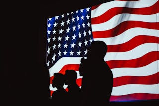 Silhouette of Four Person With Flag of United States Background