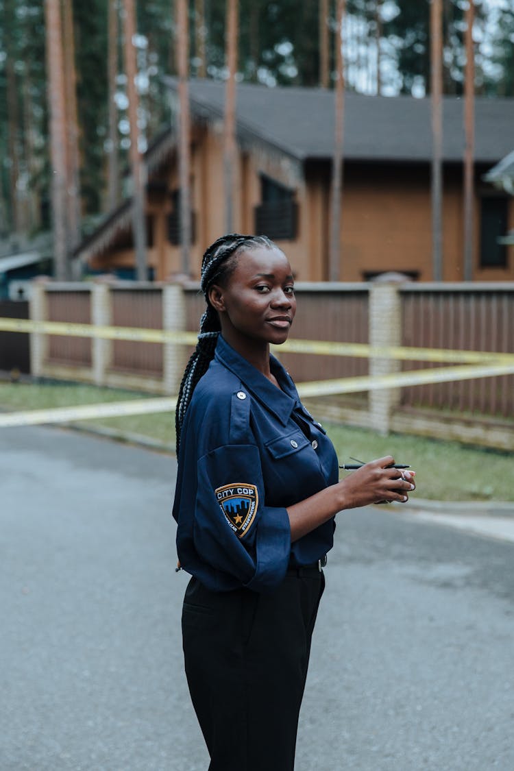 Woman With Braided Hair Wearing A Police Uniform