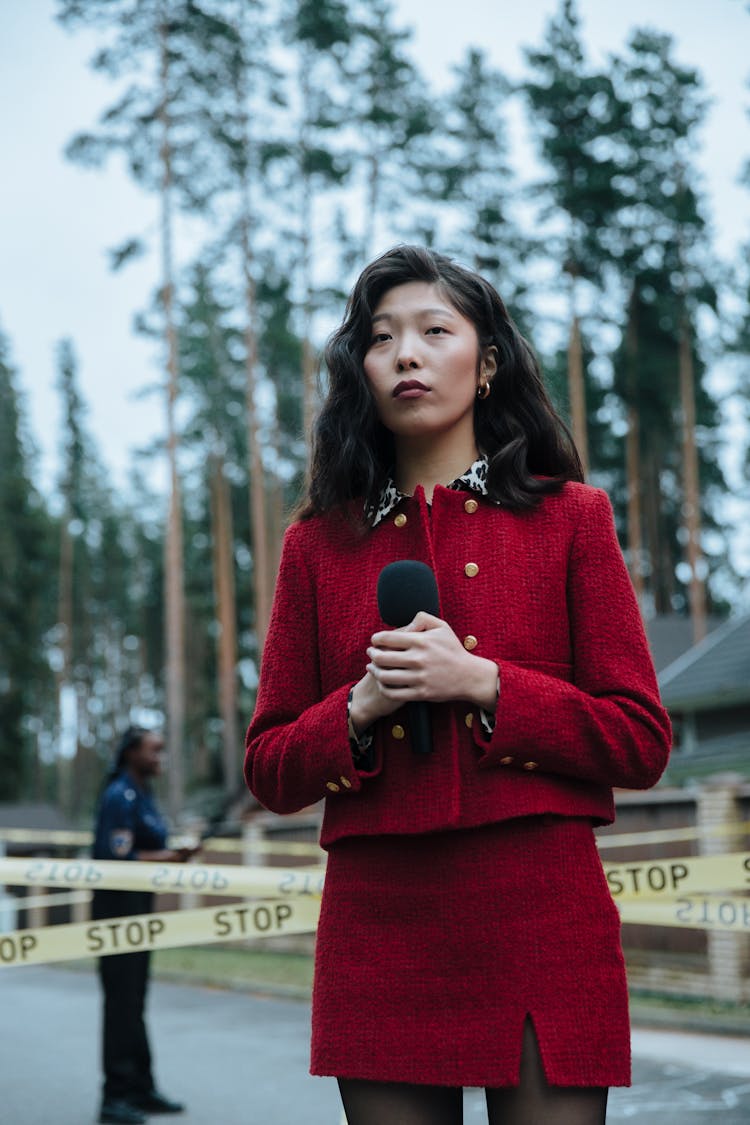 Woman Wearing Red Outfit Reporting