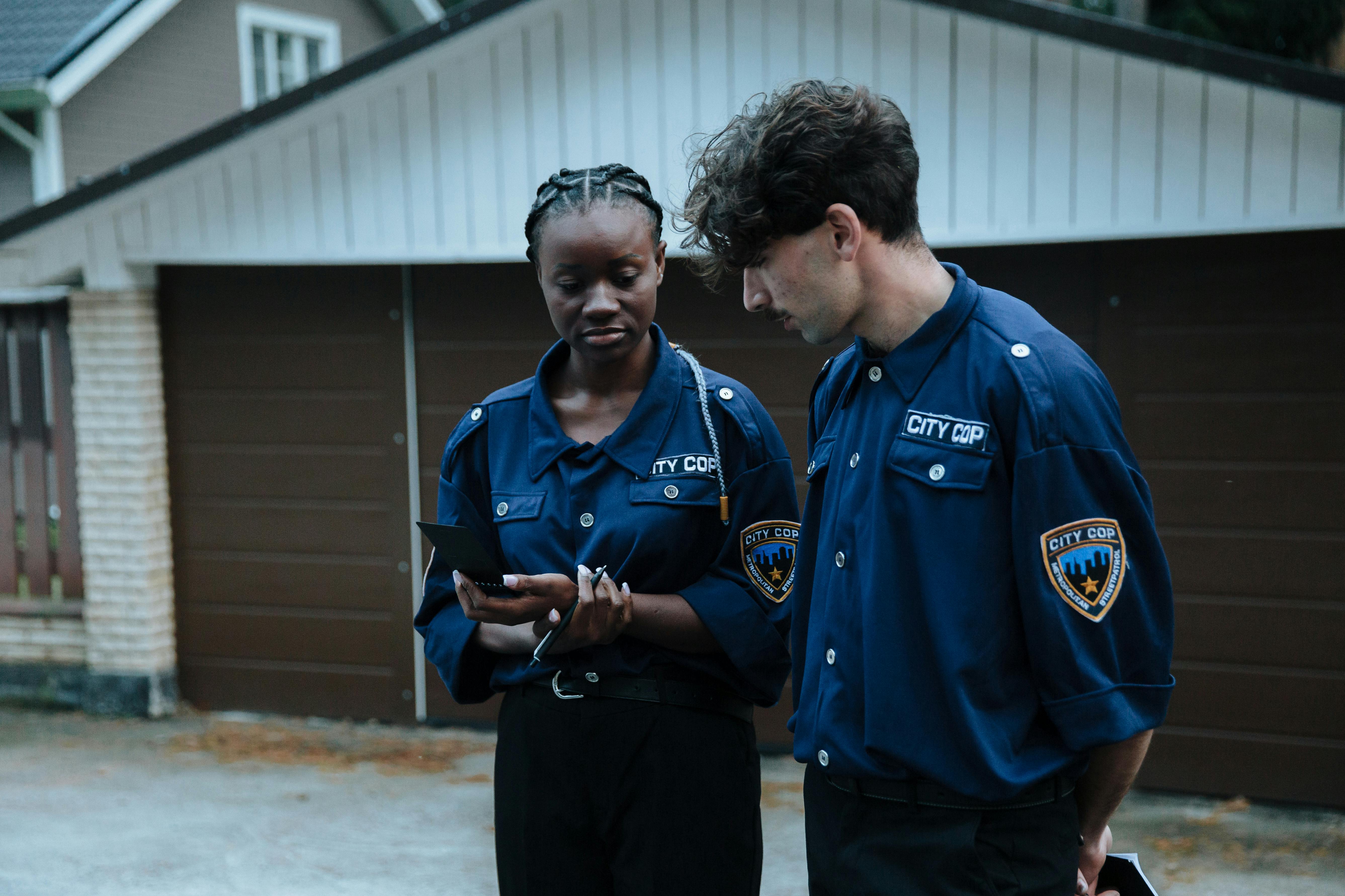 police officers having a conversation while standing near a garage