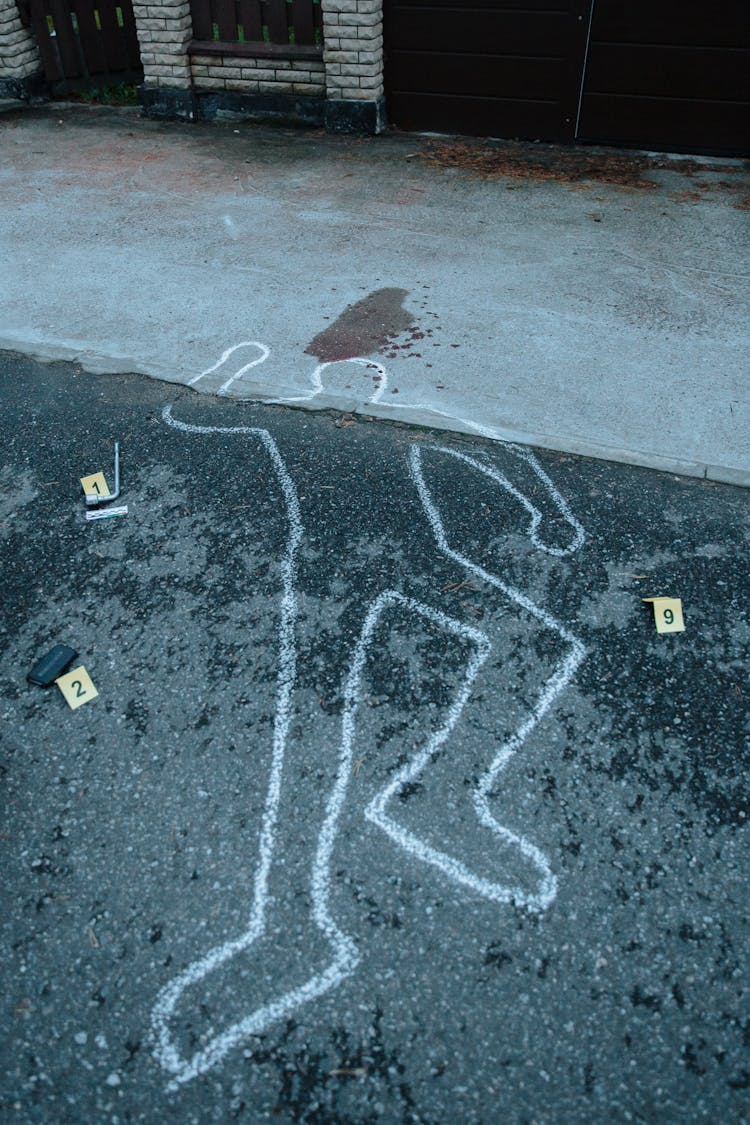 Body Marking On The Pavement Of The Crime Scene