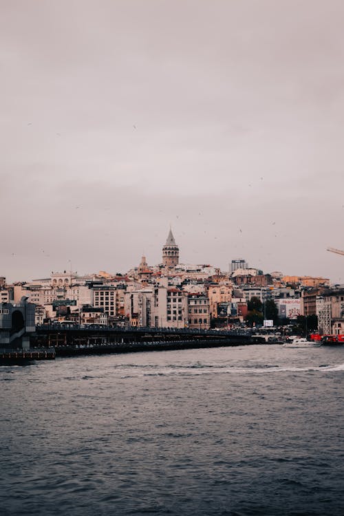 Body of Water Near City Buildings