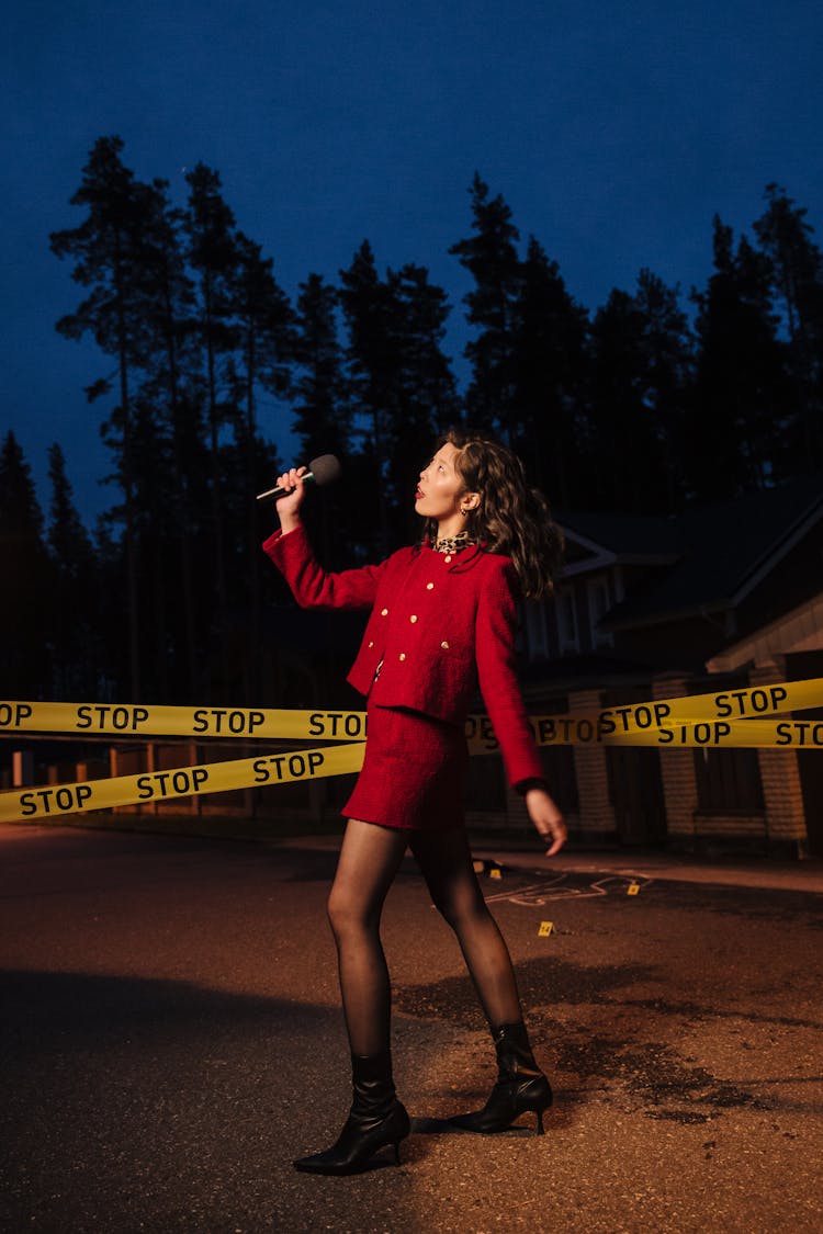 Woman Standing Beside Barricade Tape