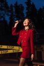 A Woman in Red Outfit Holding a Microphone