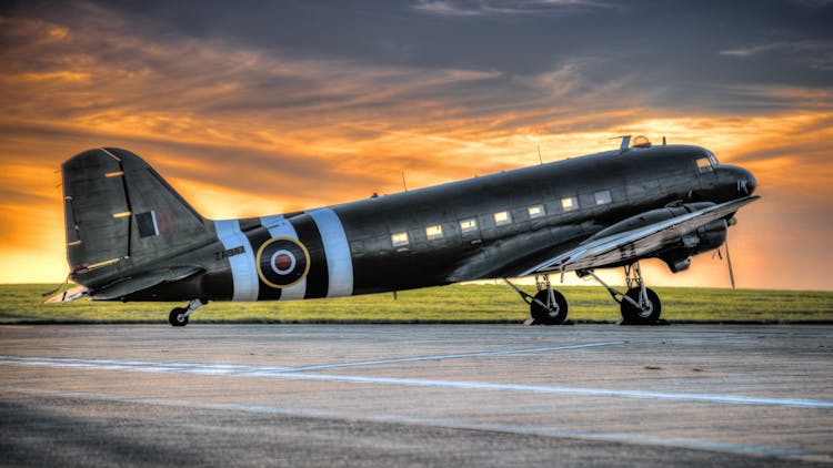 Photo Of Black And White Airplane During Golden Hour