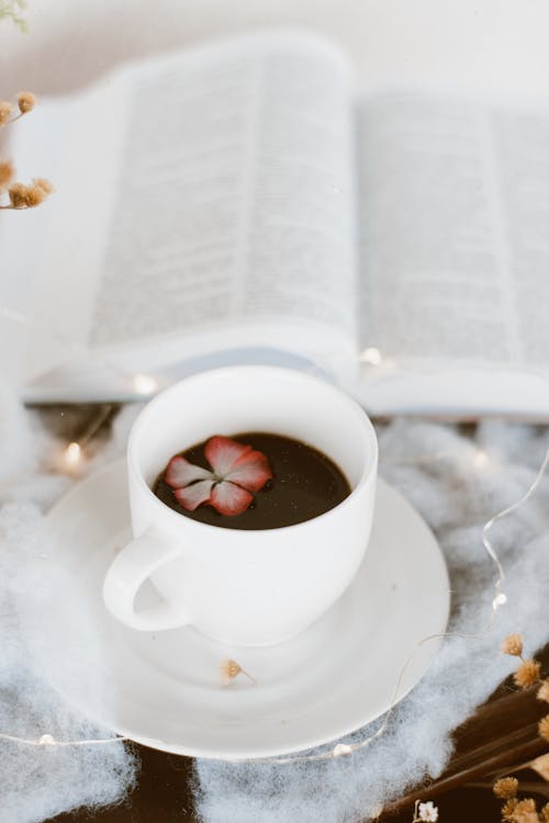 Cup of Hot Chocolate Standing Next to Open Book