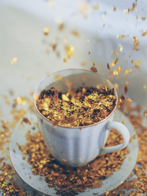Gold Confetti on Ceramic Cup