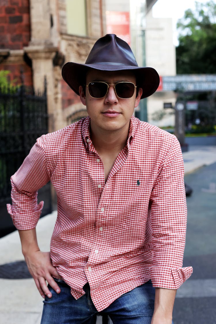 A Man In Red Checkered Long Sleeves Wearing Hat