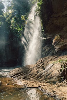 A stunning waterfall cascading in a lush Chiang Mai forest.