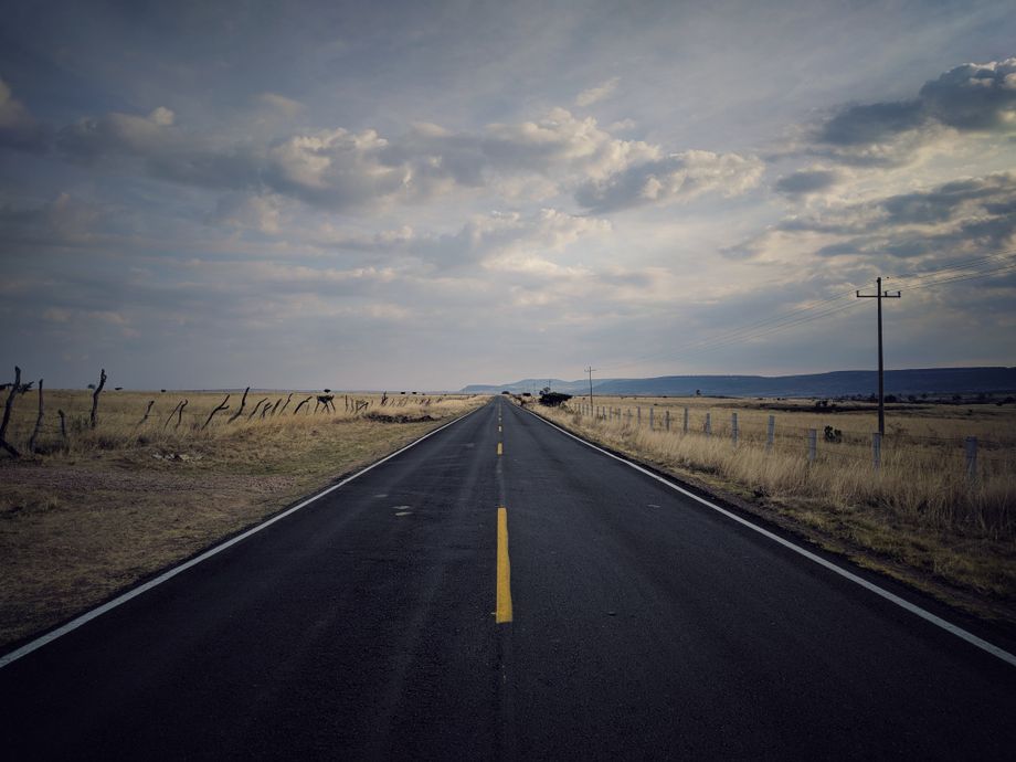 Empty desert highway running to the horizon — JC Estrada on Pexels