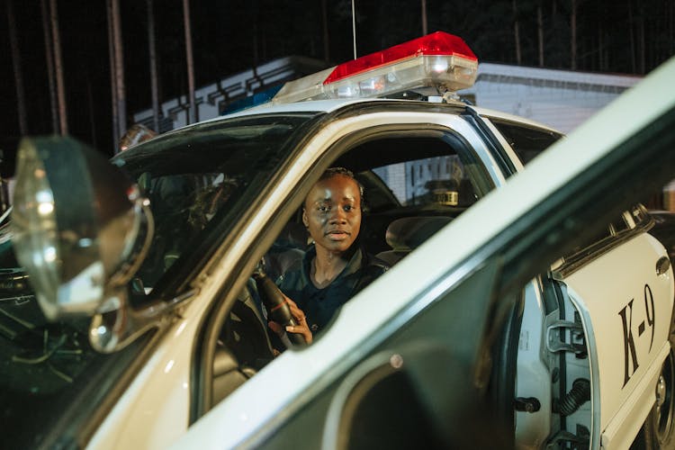 A Woman Sitting Inside The Police Car