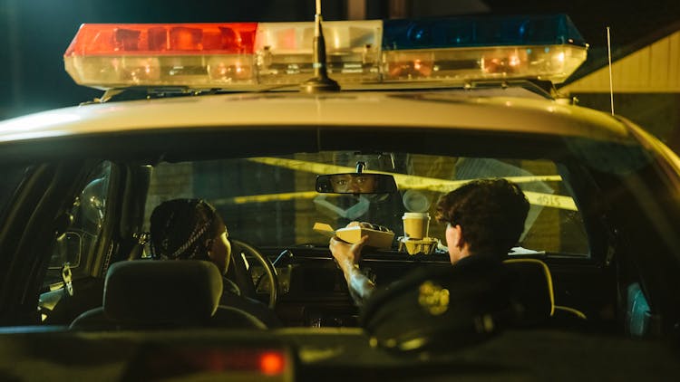 Police Officers Inside A Police Car