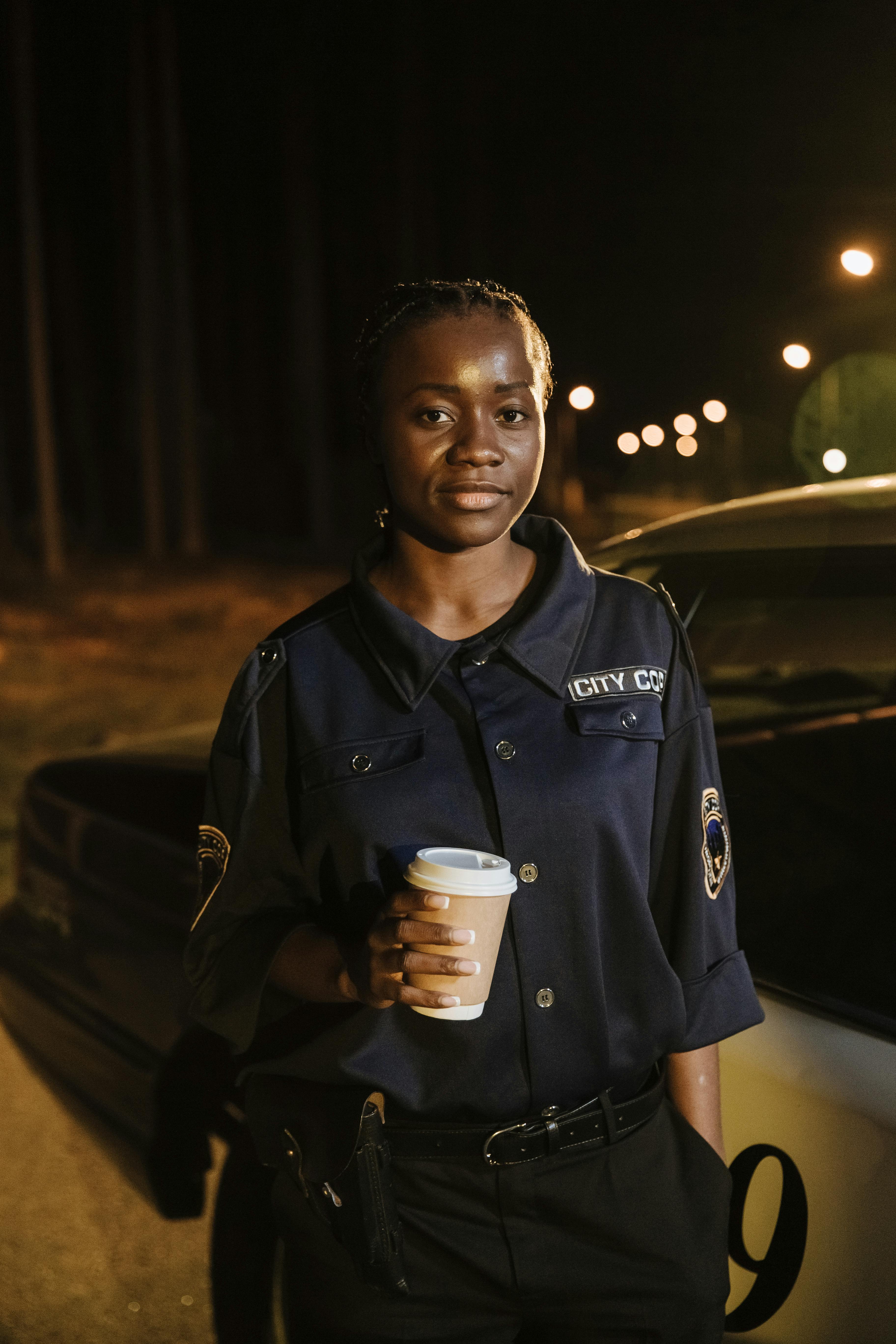 A Policewoman Holding a Coffee · Free Stock Photo
