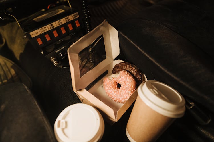 Donuts On A Box And Coffee Cups