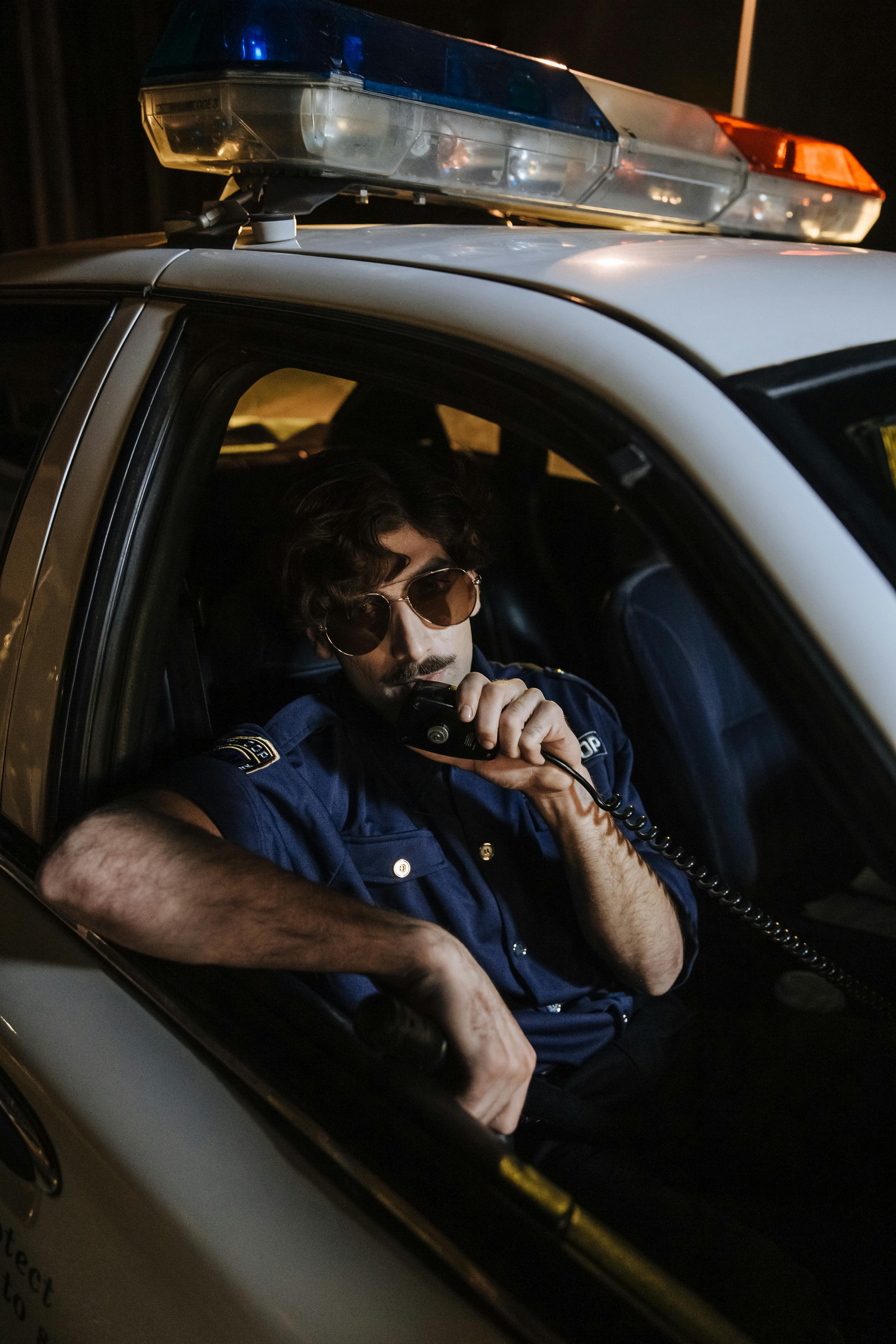 man in blue button up shirt wearing black headphones inside car