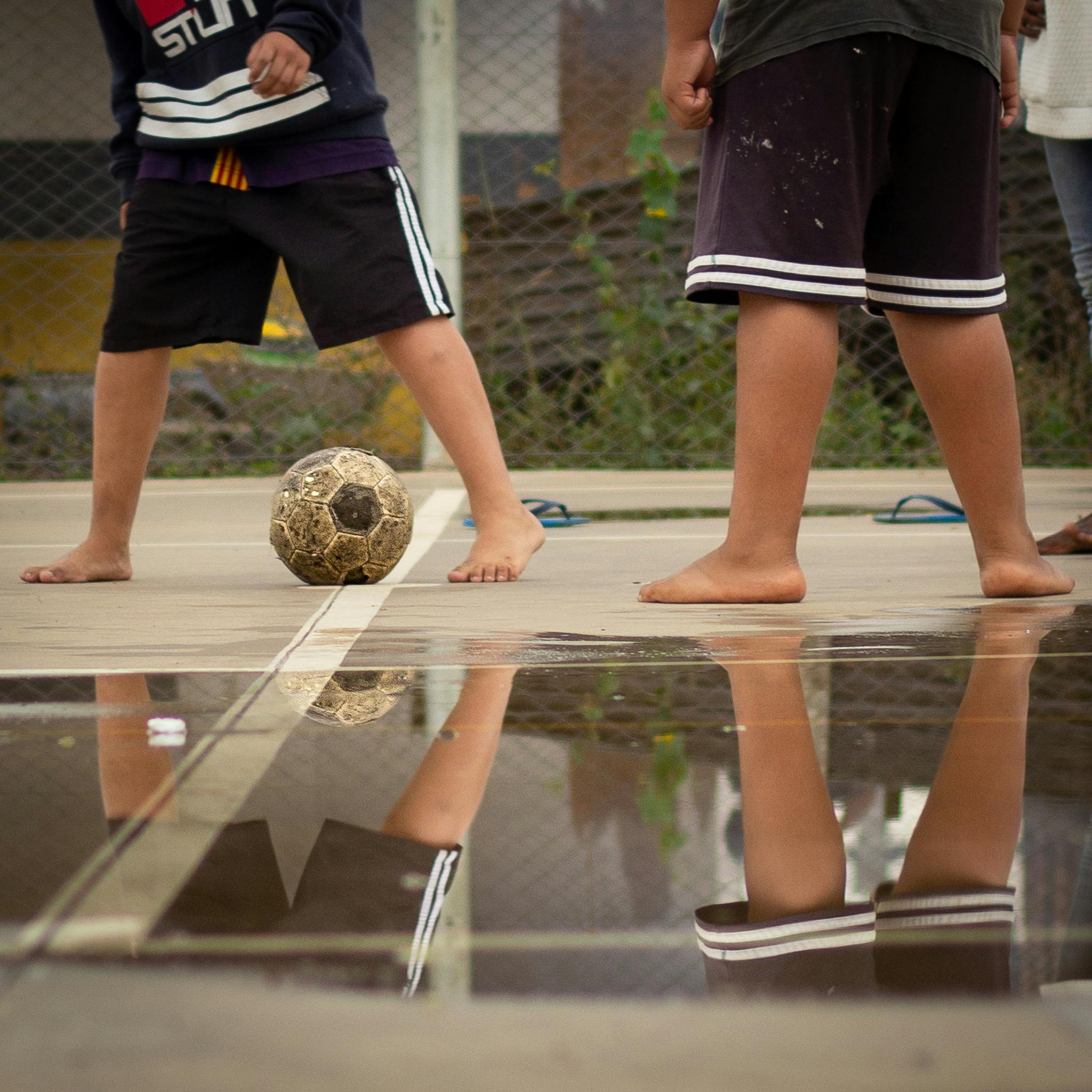 Kids Playing Football Barefoot · Free Stock Photo